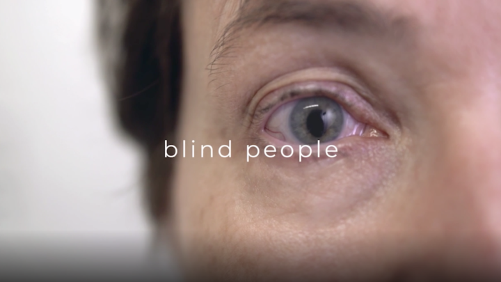 Extreme Close Up of a clouded blind eye - text on the screen reads 'blind people'