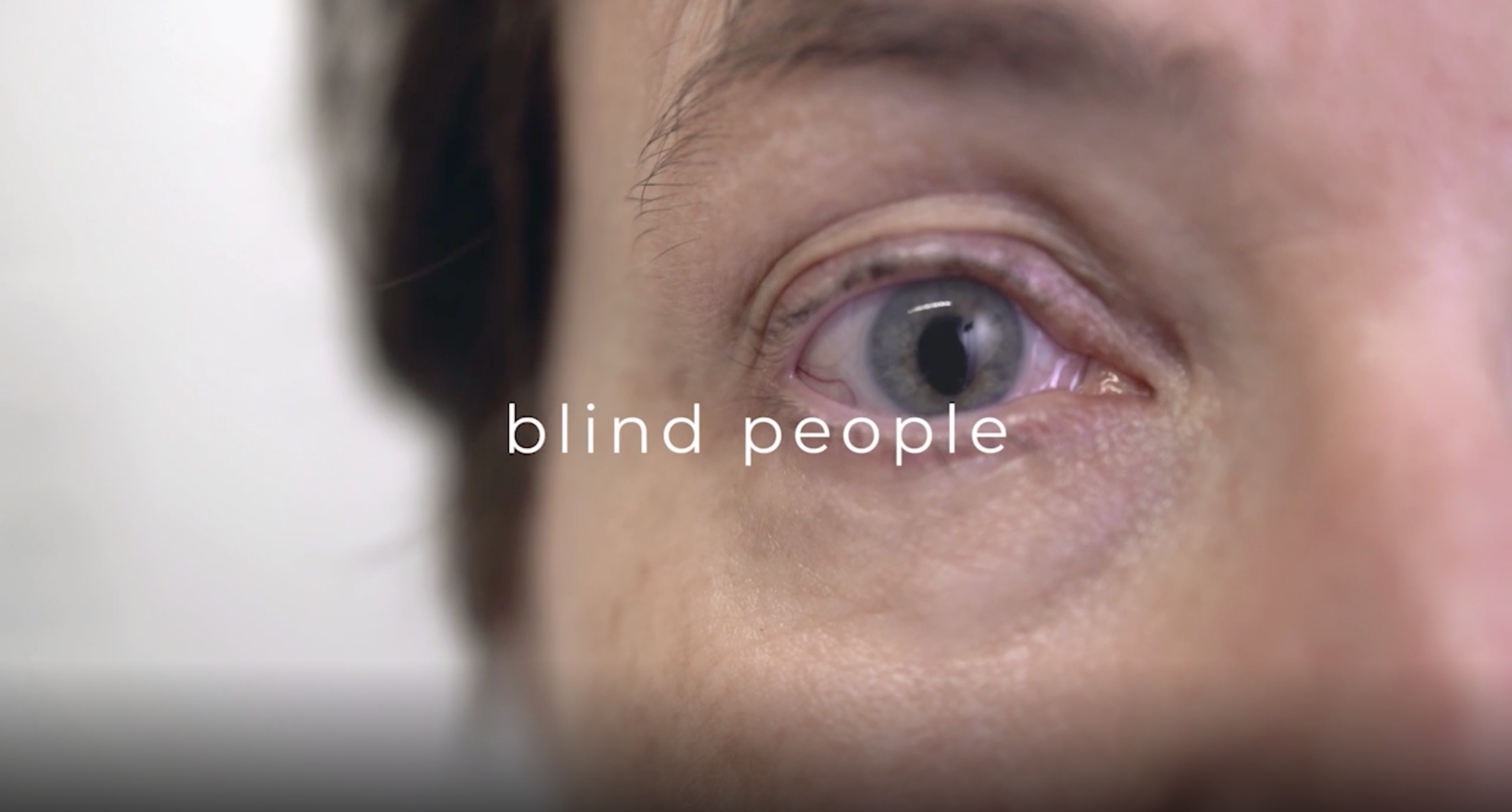 Extreme Close Up of a clouded blind eye - text on the screen reads 'blind people'