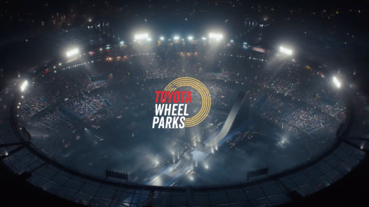 Image shows an ariel shot of a stadium with a mega ramp inside. Logo says Toyota Wheel Parks